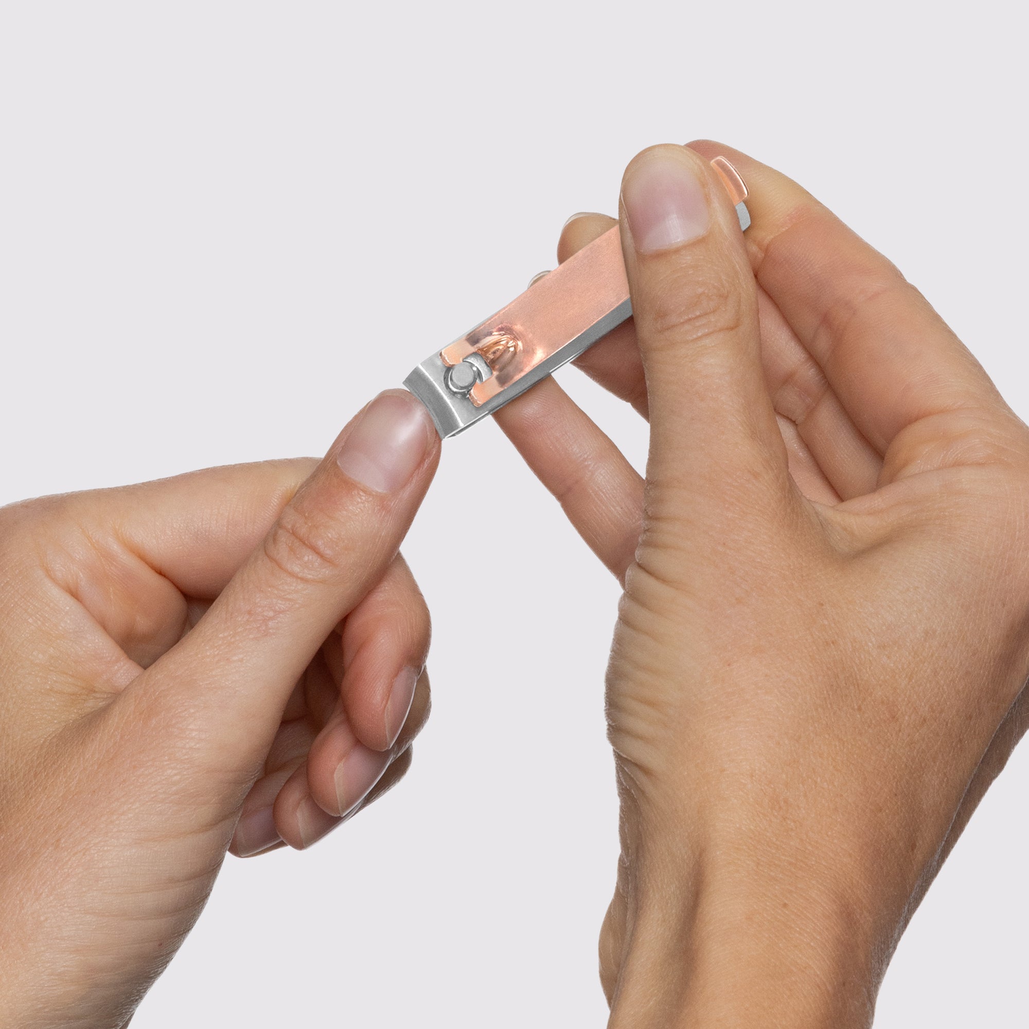 Model using Rose Gold Combo Clipper with curved blade on fingernails