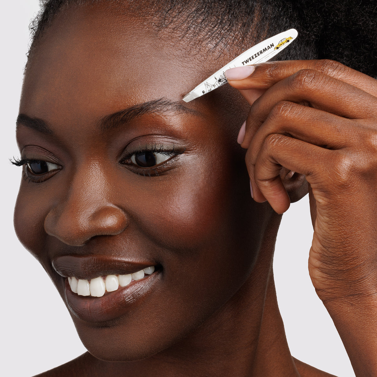 Model using the NYC Mini Slant Tweezer to tweeze brows
