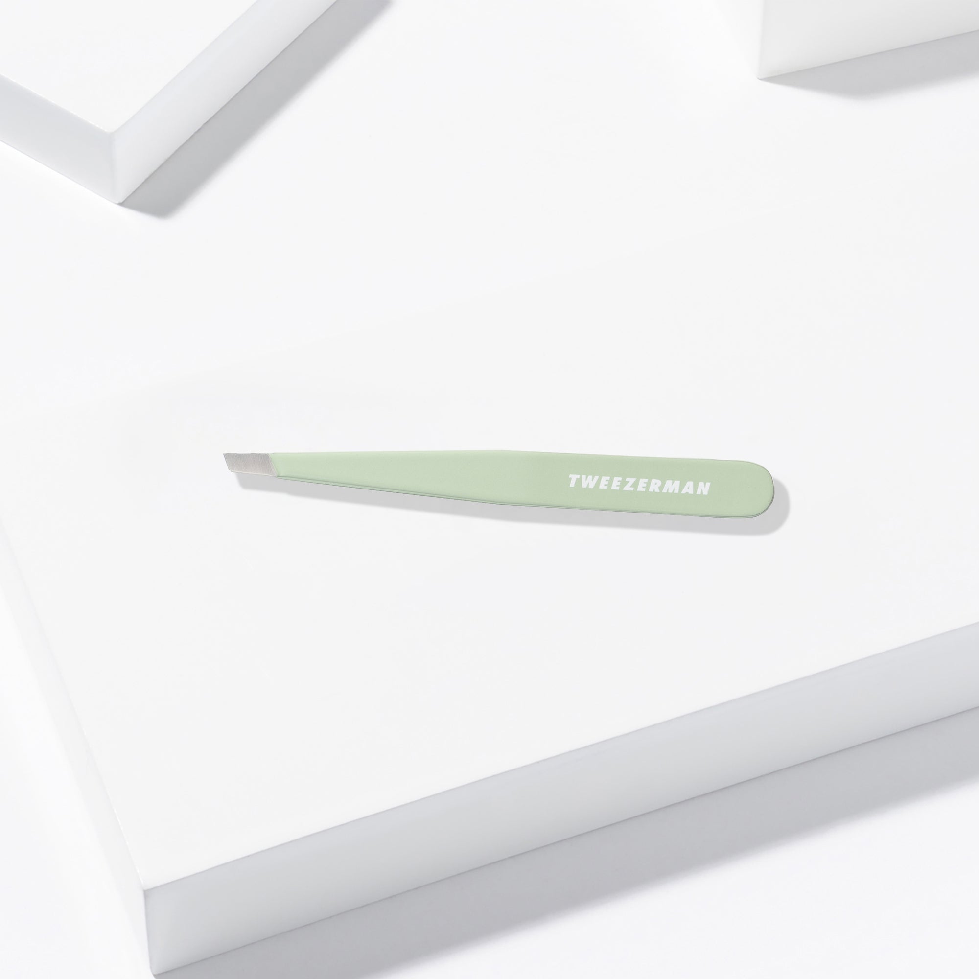 Pistachio Full Slant Tweezer placed on a white background